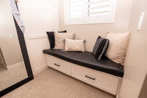 Living area with light carpet and baseboards