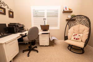 Office area with light colored carpet and baseboards