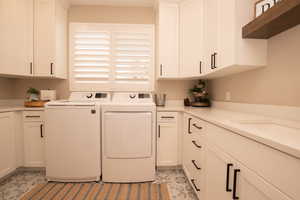 Washroom with washing machine and dryer and cabinet space