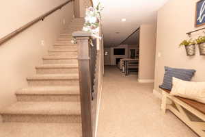 Stairs with baseboards and carpet flooring