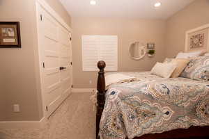 Carpeted bedroom with baseboards and recessed lighting