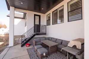 View of patio with an outdoor hangout area