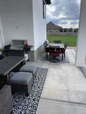 View of patio with outdoor dining space and area for grilling