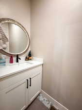 Bathroom featuring vanity and baseboards