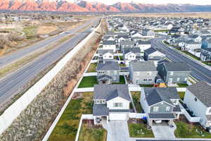 Aerial view of residential area with a main thoroughfare and a mountainous background