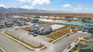 Aerial perspective of suburban area featuring a nearby body of water