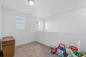 Playroom with carpet flooring and baseboards