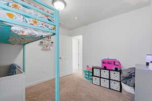 Bedroom with carpet and white refrigerator