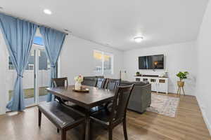 Dining space with light wood-style flooring and recessed lighting