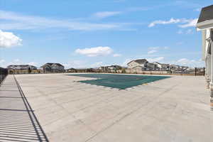 Community pool with a patio and a residential view