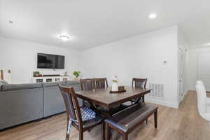 Dining room with light wood finished floors and baseboards