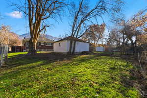 View of yard with a mountain view and an outdoor structure