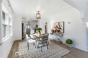 Dining space featuring wood finished floors and baseboards