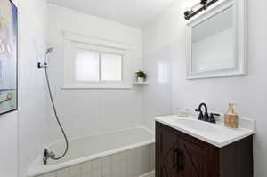 Full bathroom with vanity and tiled shower / bath combo