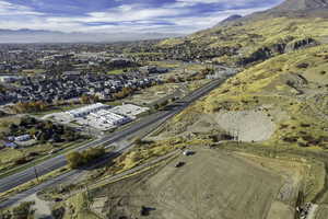 Aerial view of property and surrounding area featuring mountains