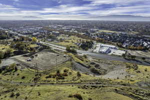 Aerial view of property and surrounding area with a mountainous background