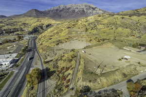Aerial view of property's location featuring a mountainous background