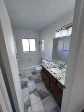 Bathroom with bathing tub / shower combination and vanity