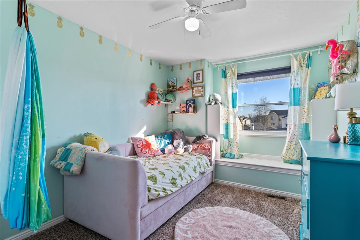Bedroom with carpet and ceiling fan