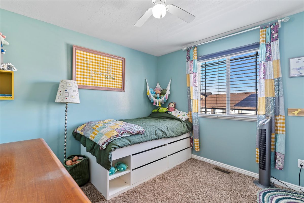 Bedroom with ceiling fan and carpet flooring