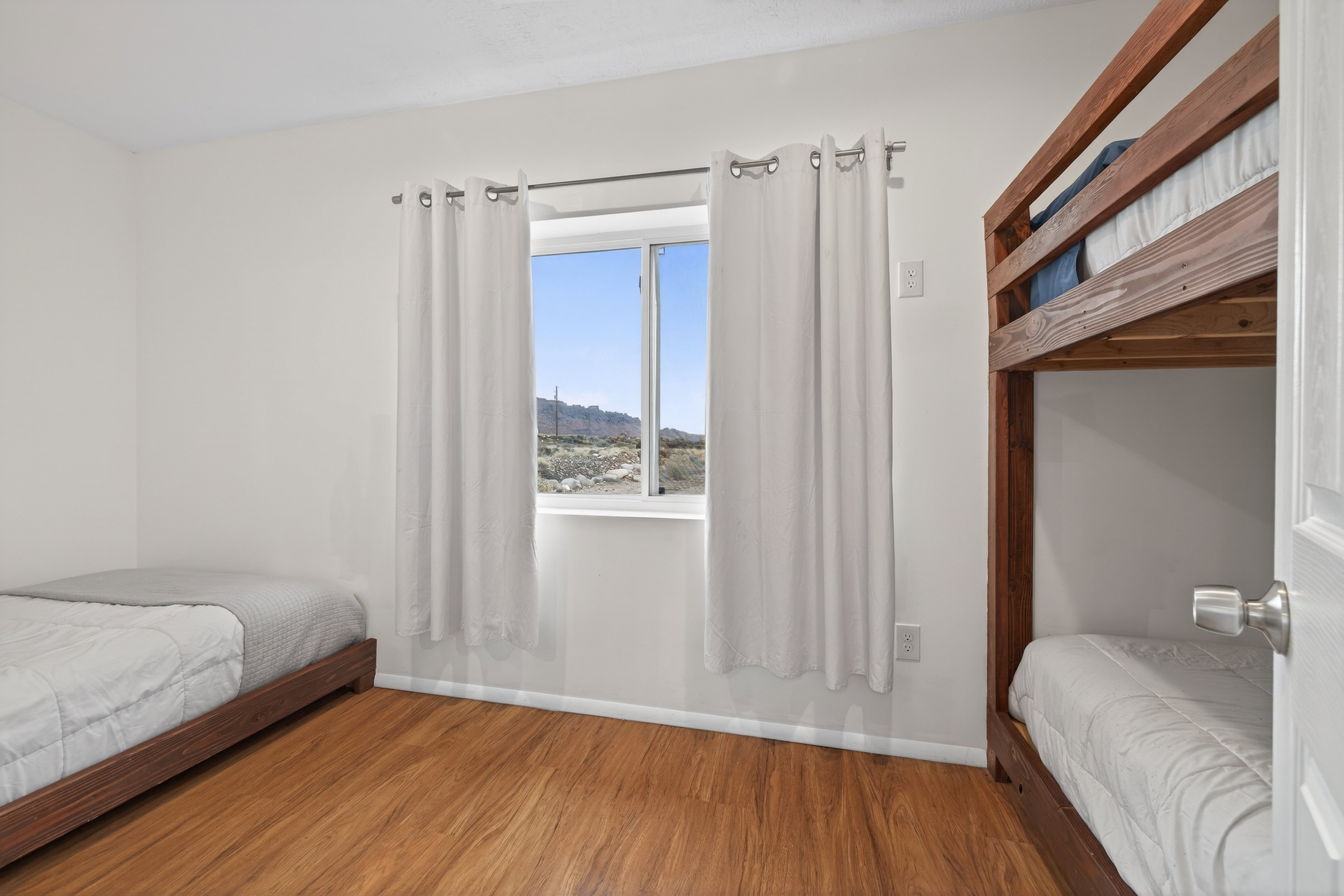 Bedroom featuring wood finished floors and baseboards