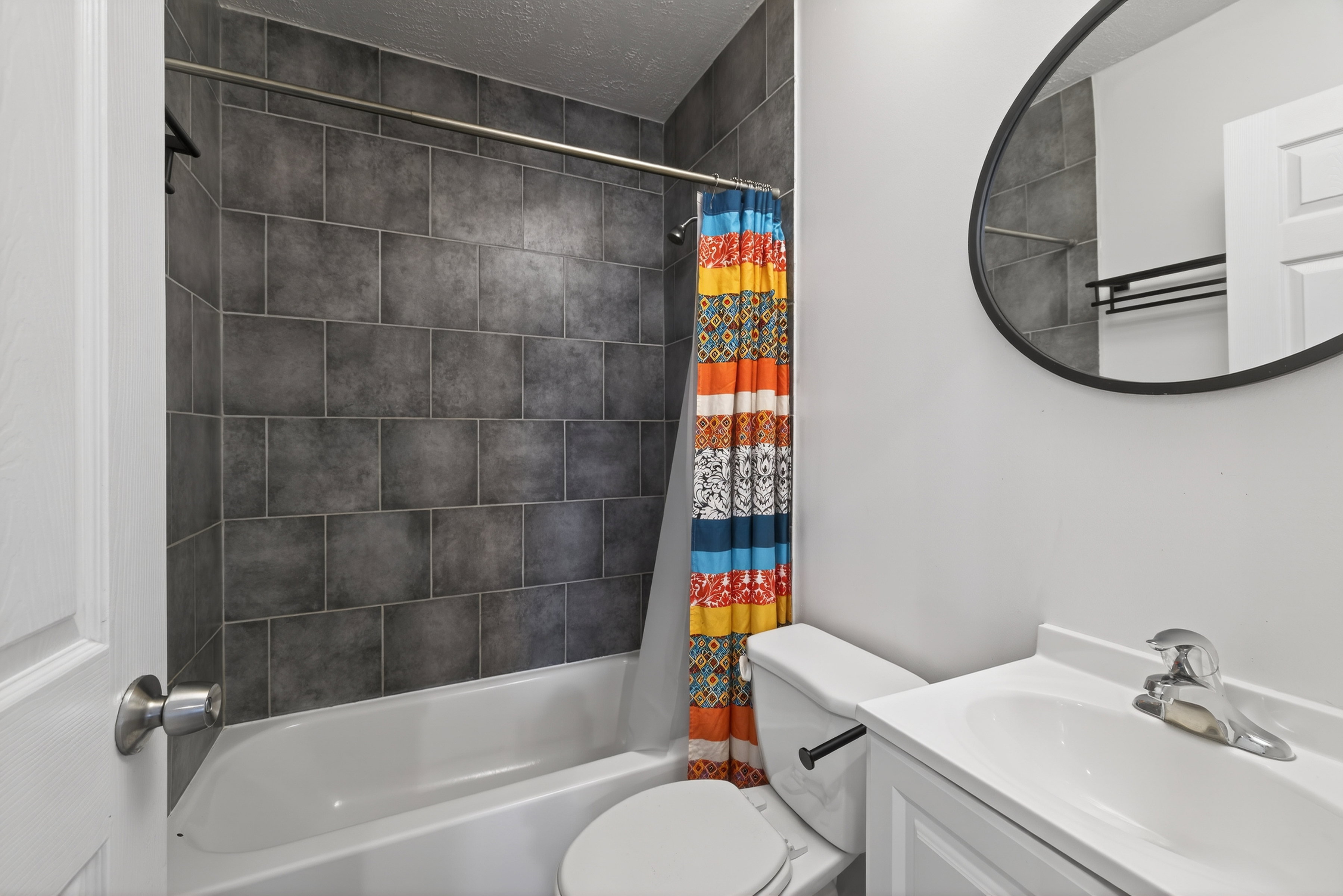 Full bath with vanity, shower / bathtub combination with curtain, and a textured ceiling