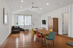 Dining area featuring a ceiling fan, wood finished floors, recessed lighting, and a high ceiling