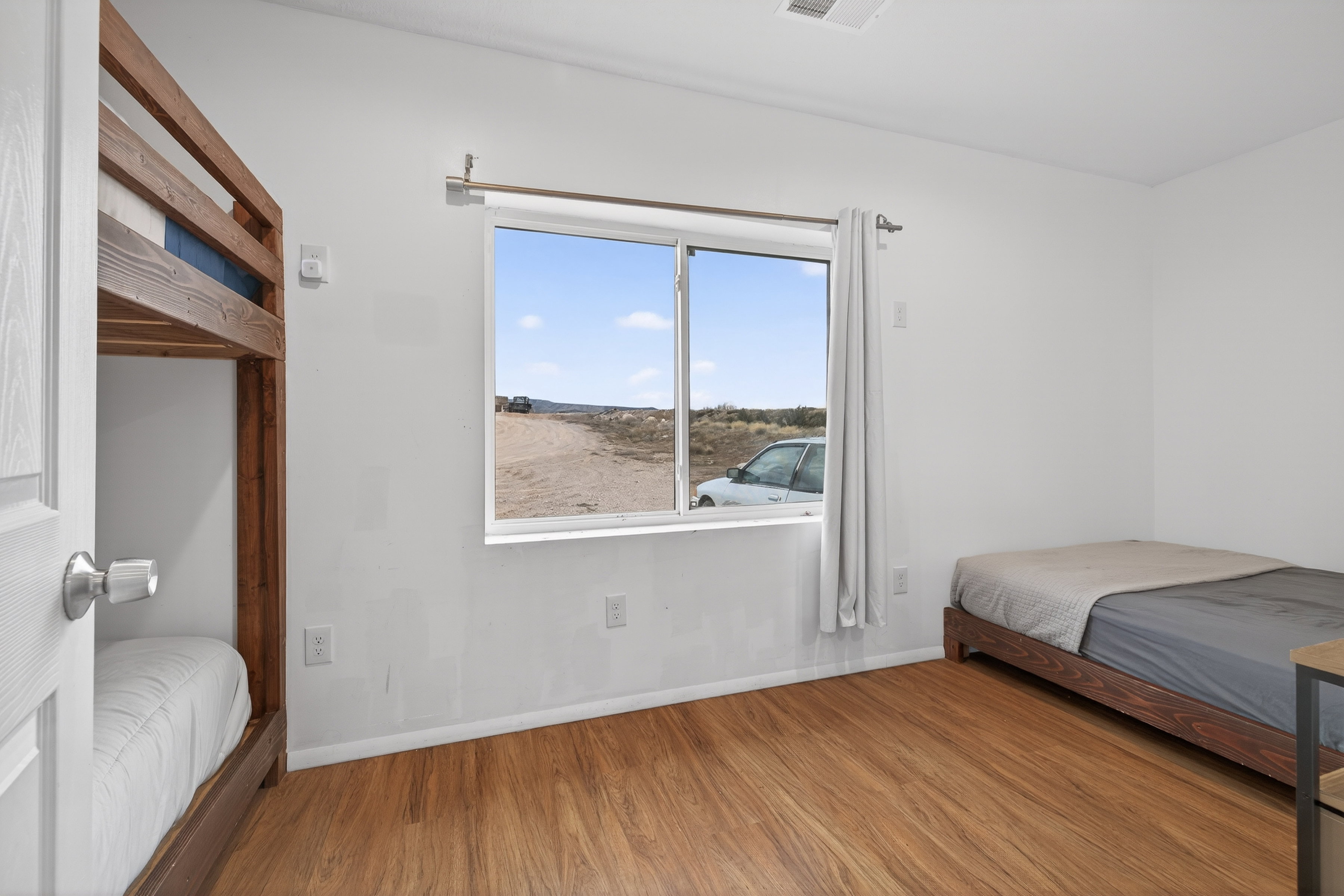 Bedroom with wood finished floors and baseboards