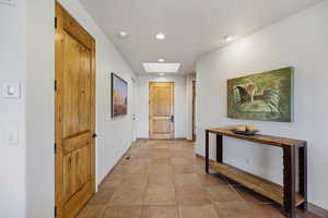 Hallway featuring recessed lighting and a skylight