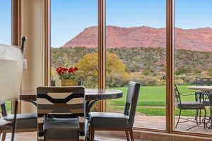 Sunroom / solarium featuring a mountain view and healthy amount of natural light