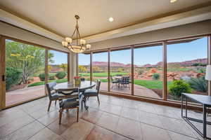 Tiled dining area with a mountain view, a chandelier, and recessed lighting