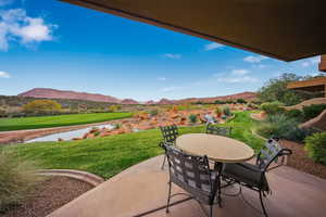 View of patio / terrace with outdoor dining area, a mountain view, and view of golf course