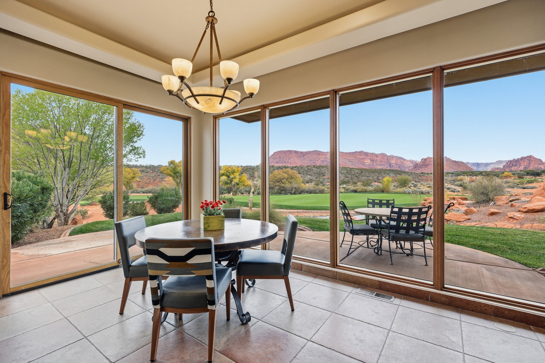 Tiled dining area featuring a mountain view, a chandelier, and view of golf course