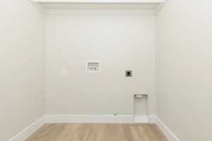 Laundry area featuring washer hookup, light wood-style flooring, and hookup for an electric dryer