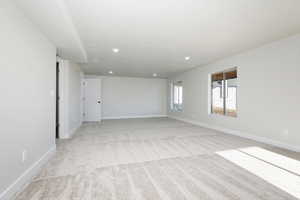 Unfurnished room with light carpet and recessed lighting