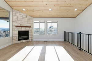 Unfurnished living room with wooden ceiling, a fireplace, recessed lighting, and light wood-style flooring