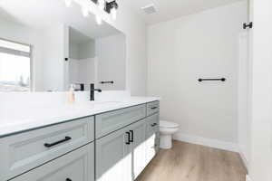 Full bathroom with vanity and light wood-style floors