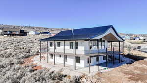 Rear view of house featuring a metal roof