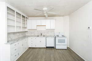 Kitchen with white appliances, white cabinets, ceiling fan, dark wood-style flooring, and open shelves