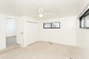 Unfurnished bedroom with carpet flooring, a closet, and a ceiling fan