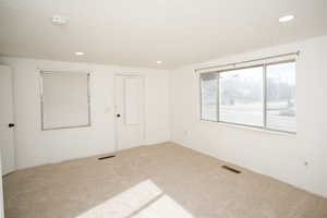 Spare room with recessed lighting, carpet floors, and a smoke detector