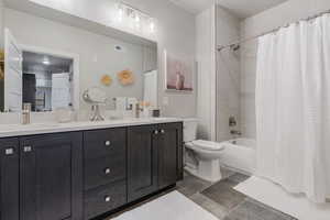 Full bath with shower / bath combo and double vanity