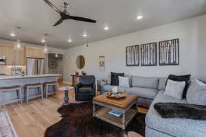 Living area with recessed lighting, light wood-style floors, and a ceiling fan
