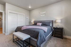 Carpeted bedroom featuring a closet and recessed lighting