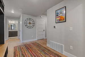 Corridor with light wood-style flooring