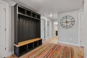 Mudroom featuring baseboards and light wood-type flooring