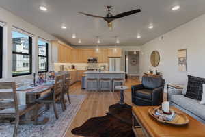 Dining space featuring light wood-style flooring, a ceiling fan, and recessed lighting