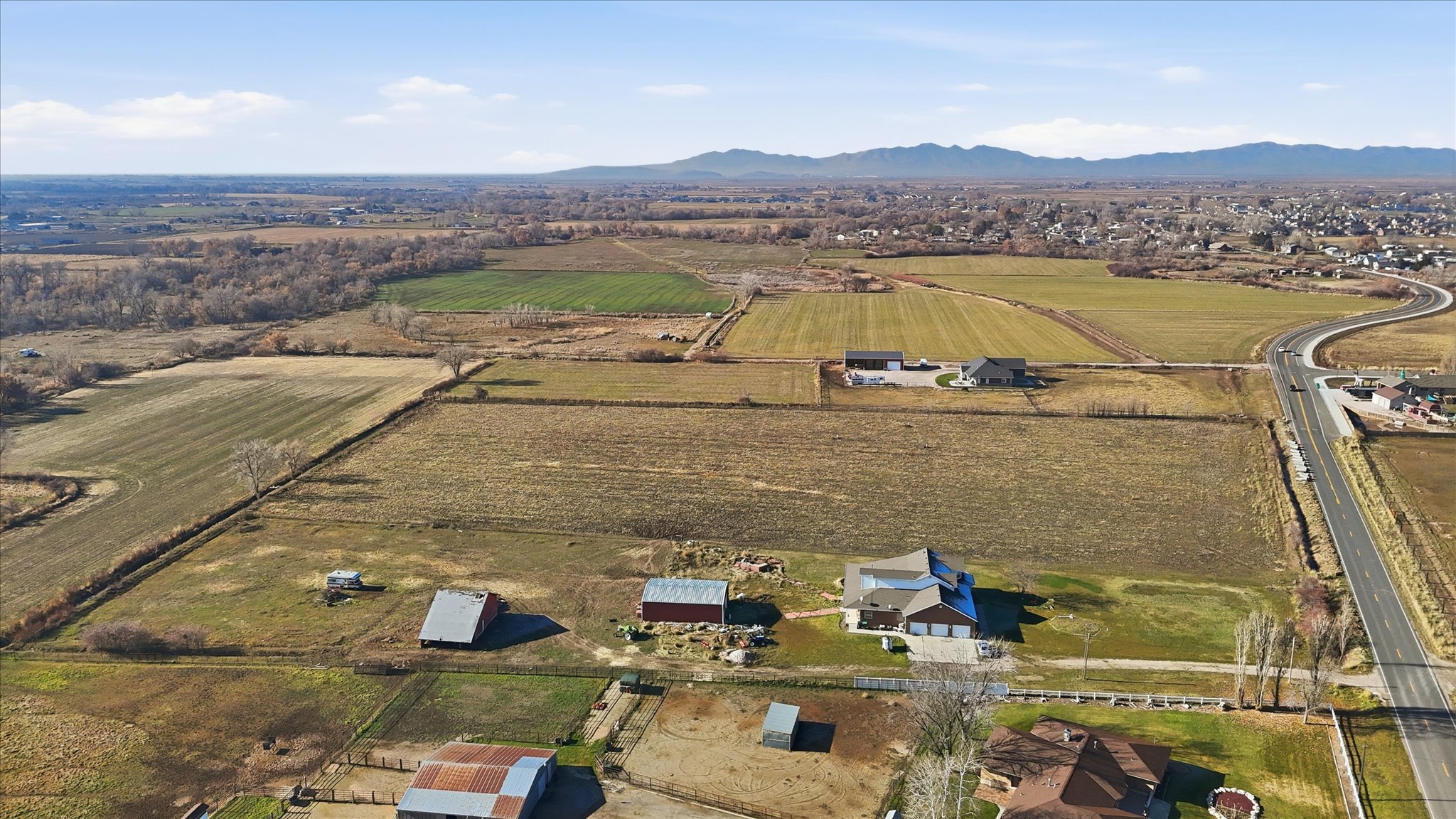 Aerial overview of property's location featuring rural landscape, abundant farmland, and mountains