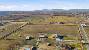 Aerial overview of property's location featuring rural landscape, abundant farmland, and mountains