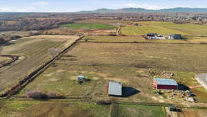 Overview of rural landscape with large plots for crops and a mountain backdrop